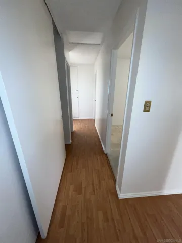 a view of a hallway with wooden floor