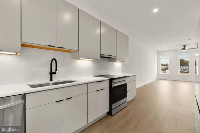 a view of a kitchen with a refrigerator and a window