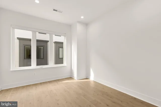 a bathroom with a granite countertop sink a toilet and a bathtub