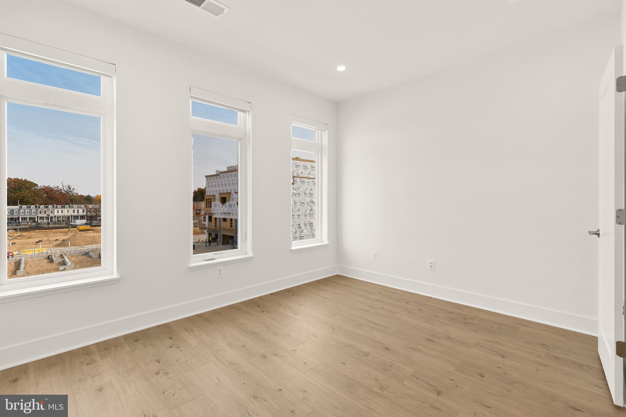 2608 Olmsted Court Northwest Washington, DC 20422 - Photo 29 of 39 an empty room with wooden floor and windows