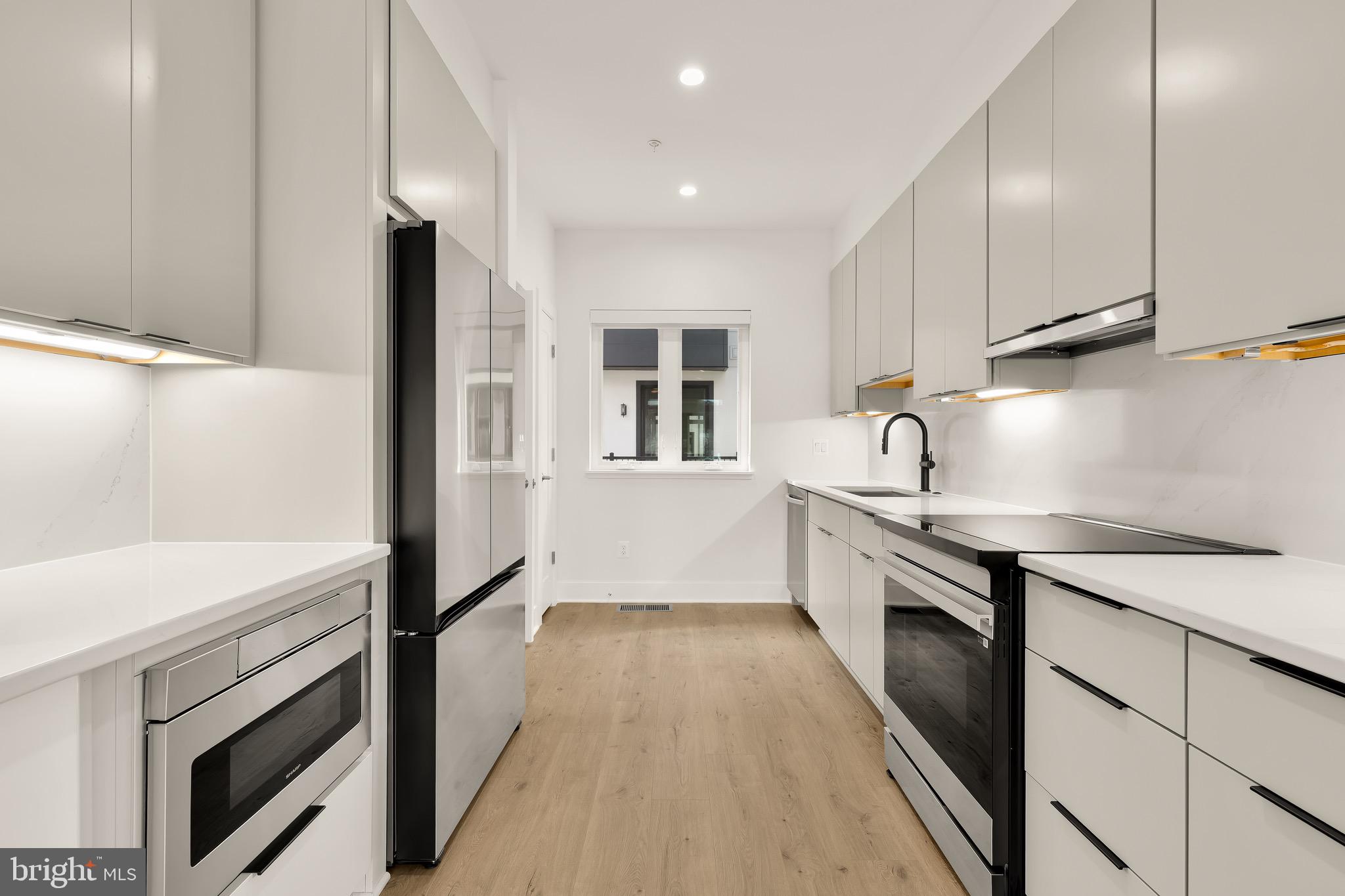 2608 Olmsted Court Northwest Washington, DC 20422 - Photo 9 of 39 a kitchen with granite countertop white cabinets and white appliances