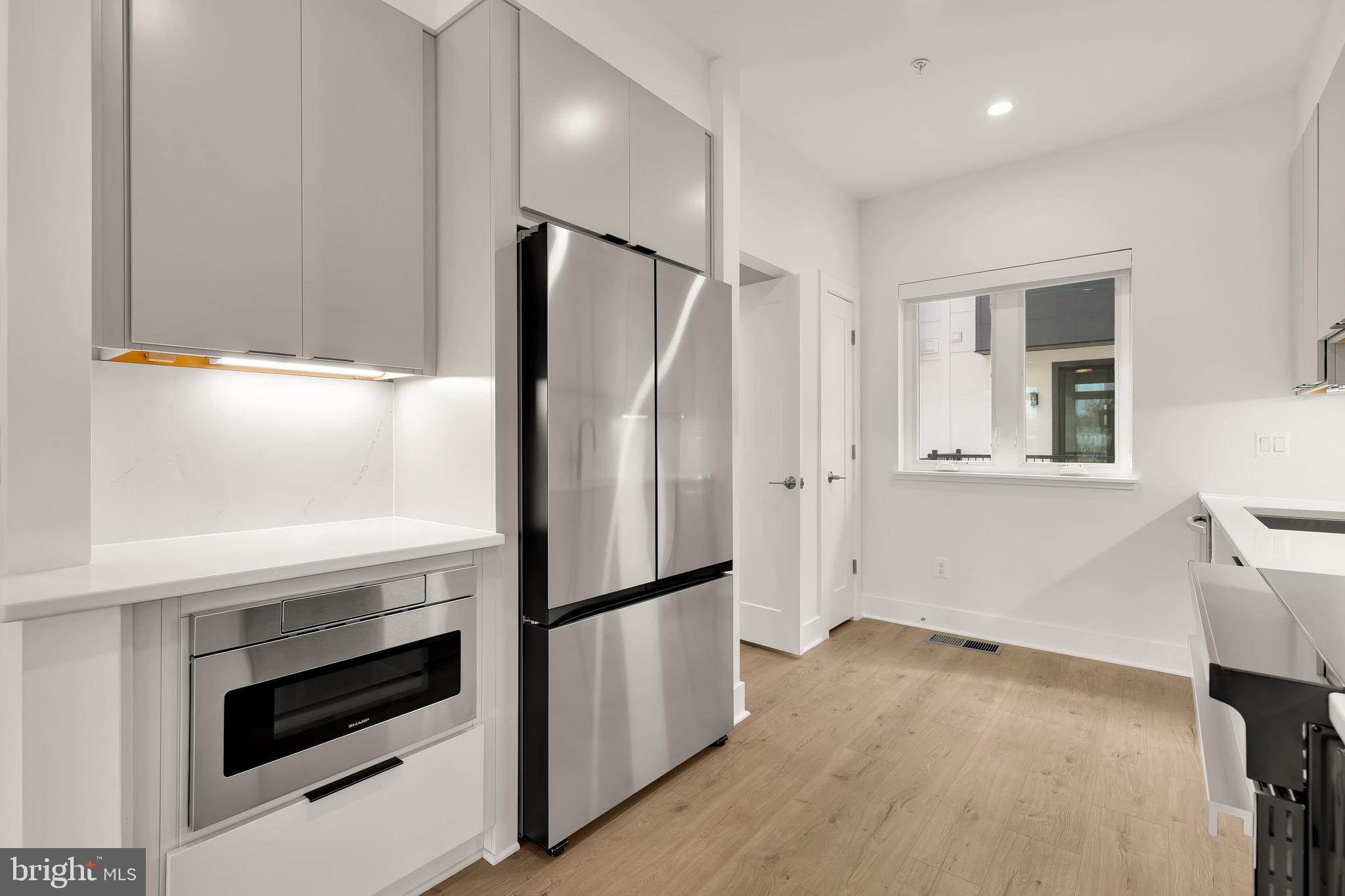 2608 Olmsted Court Northwest Washington, DC 20422 - Photo 10 of 39 a kitchen with a refrigerator and a stove top oven
