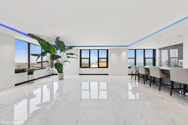 a living room with furniture potted plant and a window