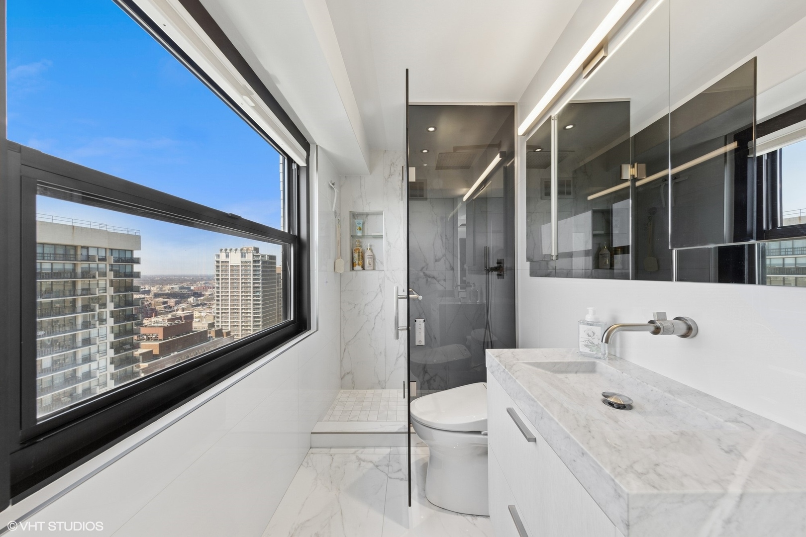 3150 North Lake Shore Drive, Unit 27F Chicago, IL 60657 - Photo 21 of 31 a bathroom with a sink toilet and shower