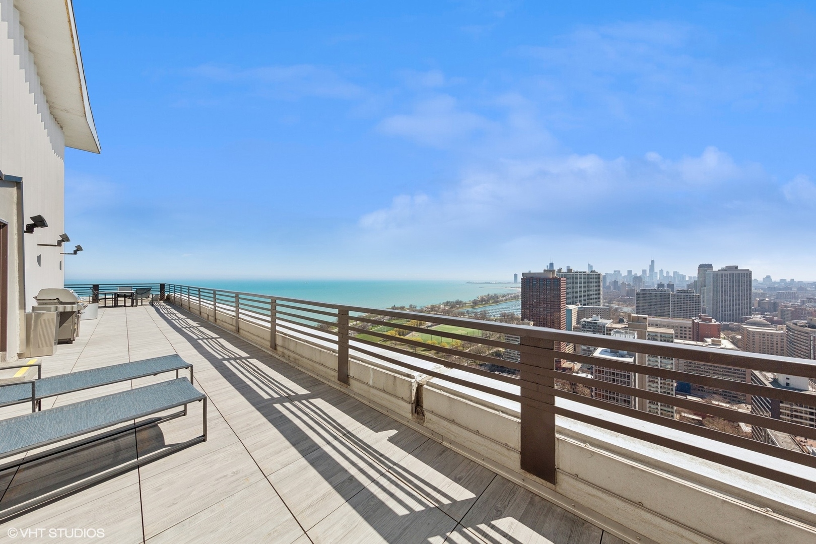 3150 North Lake Shore Drive, Unit 27F Chicago, IL 60657 - Photo 29 of 31 a view of a balcony with wooden floor and city view