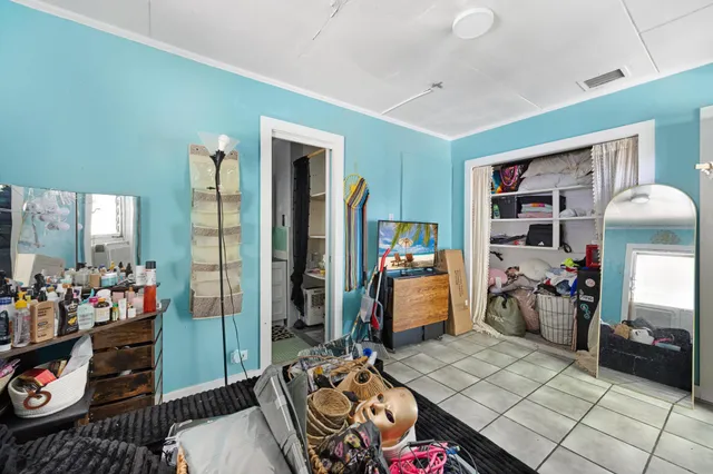 a bedroom with a bed and a flat tv screen