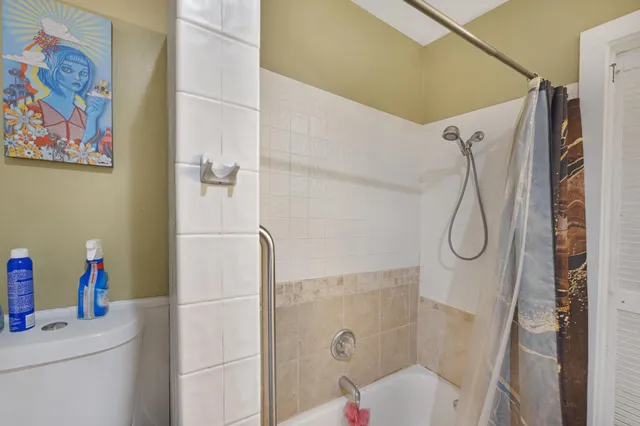 a bathroom with a sink a toilet and shower curtain