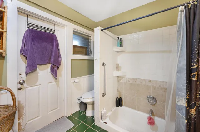 a bathroom with a toilet sink and mirror
