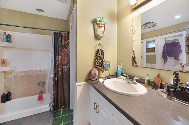 a bedroom with furniture and a large window