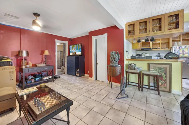 a bedroom with a bed and large windows