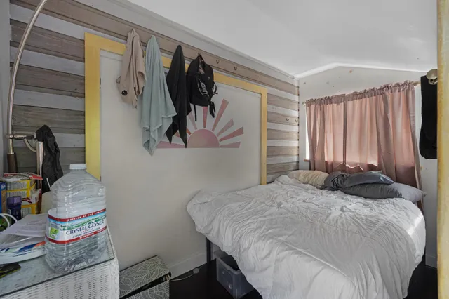 a bedroom with a bed and a walk in closet