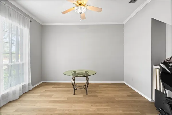 a view of a room with wooden floor and a window