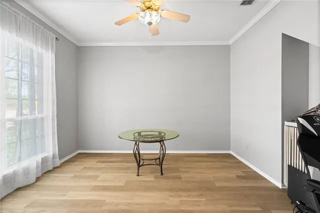 a view of a room with wooden floor and a window