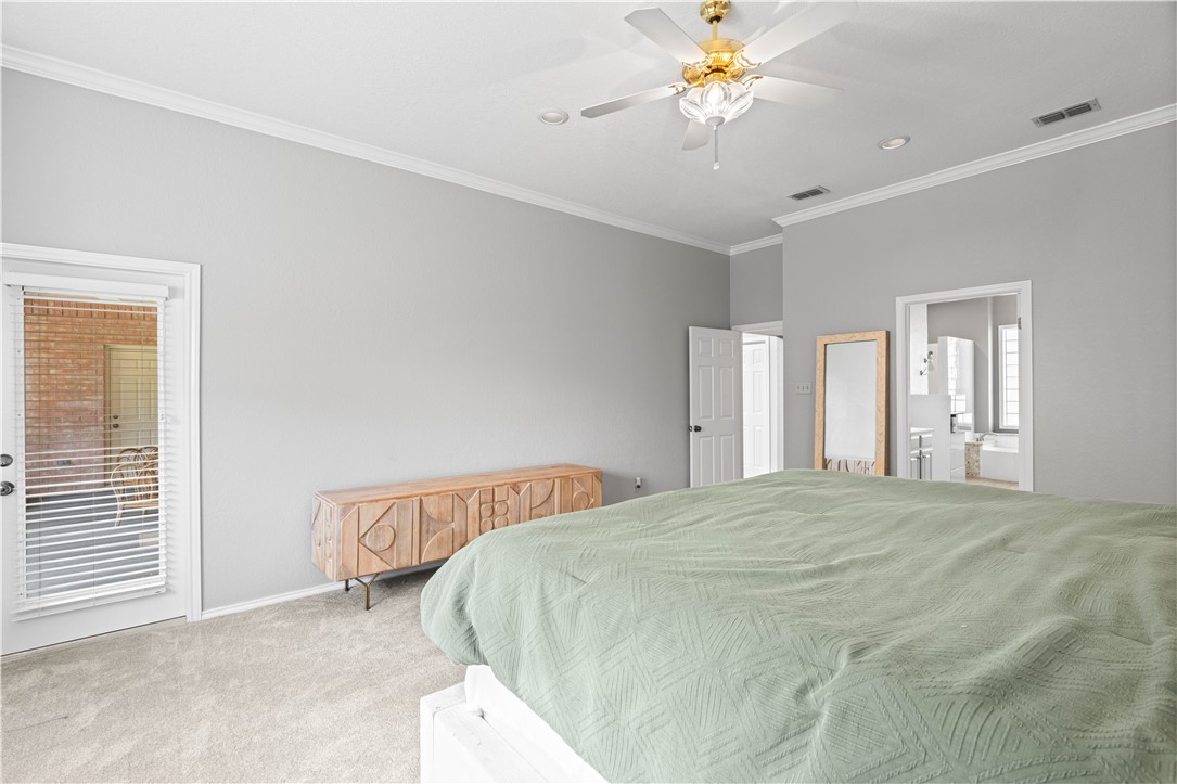 4406 Pontchartrain Drive Corpus Christi, TX 78413 - Photo 14 of 21 a bedroom with a bed and a chandelier