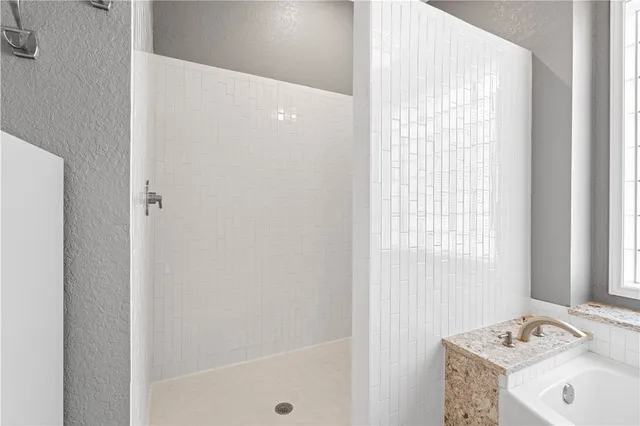 a bathroom with a tub sink and mirror
