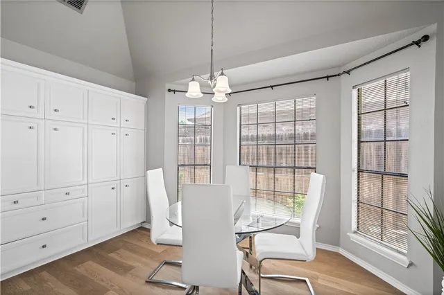 a view of a dining room with furniture large windows and wooden floor