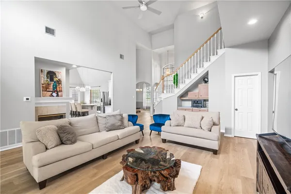a living room with furniture and a wooden floor