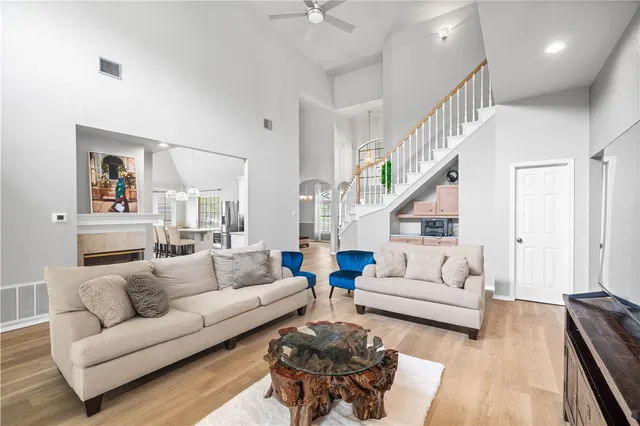 a living room with furniture and a wooden floor