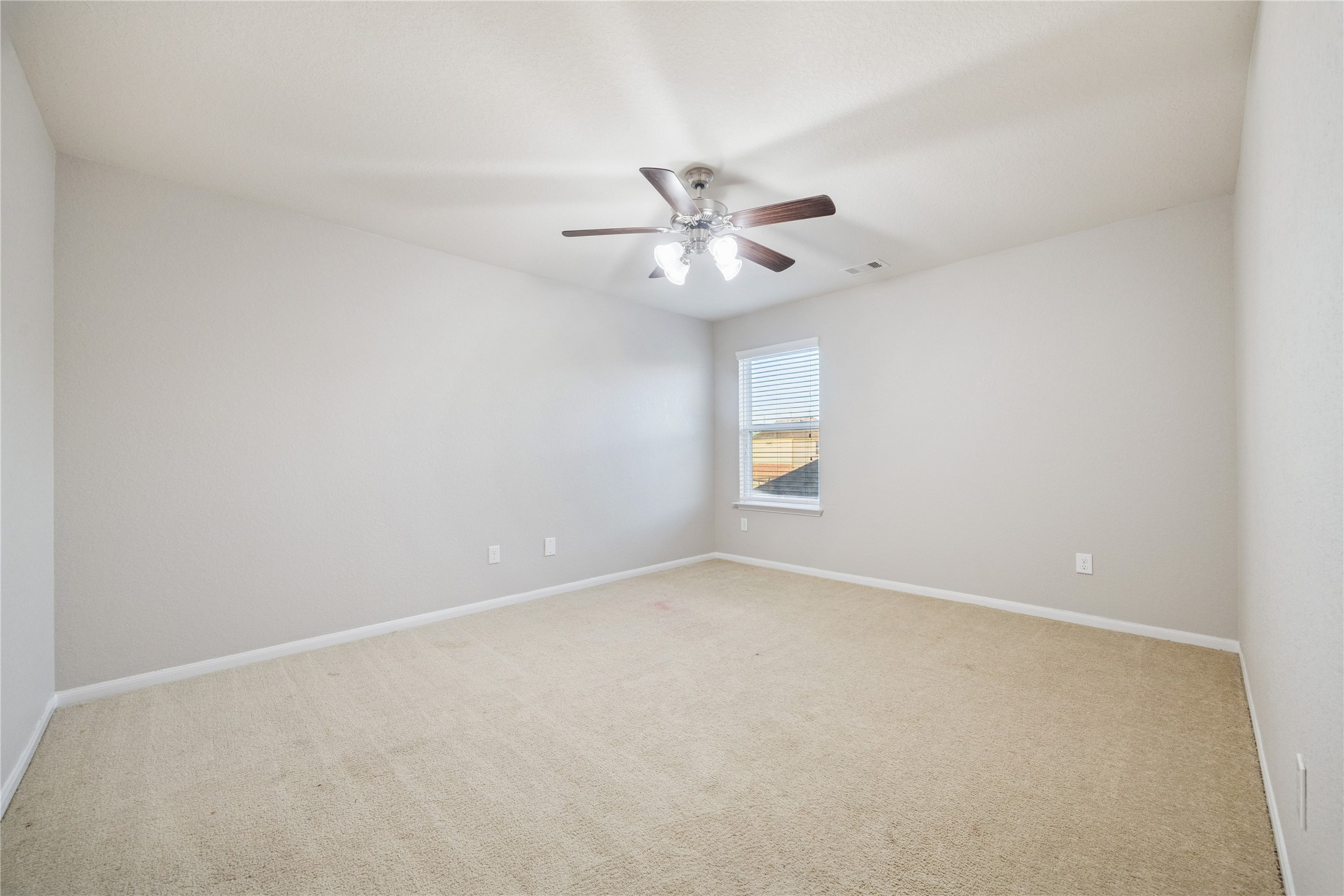 3026 Currier Court Rosenberg, TX 77471 - Photo 17 of 22 an empty room with a window and a ceiling fan