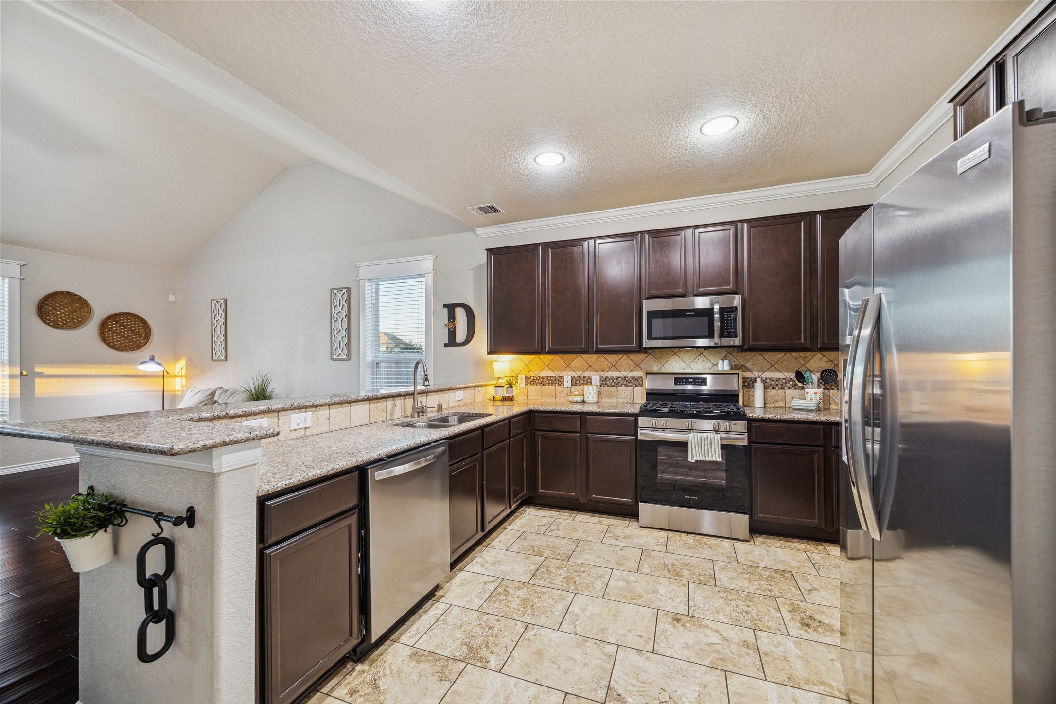 3026 Currier Court Rosenberg, TX 77471 - Photo 10 of 22 a kitchen with stainless steel appliances granite countertop a sink and cabinets