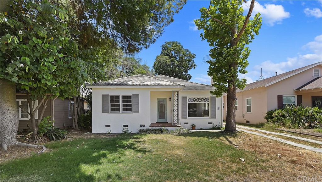 a front view of house with yard and green space