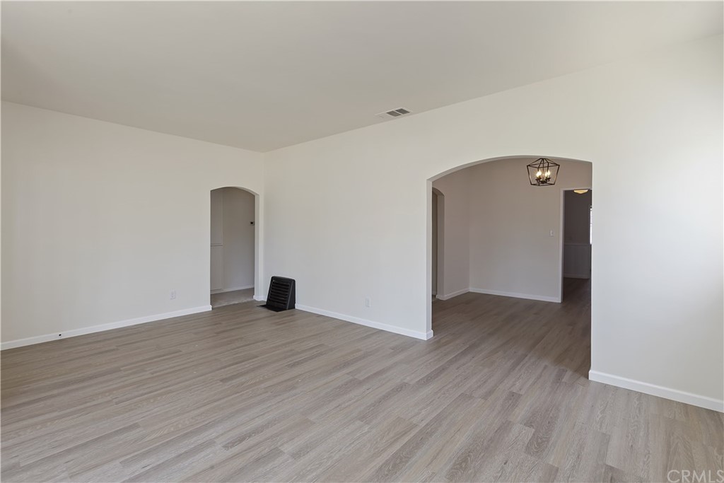 6650 Palm Avenue Riverside, CA 92506 - Photo 3 of 20 an empty room with wooden floor and mirror