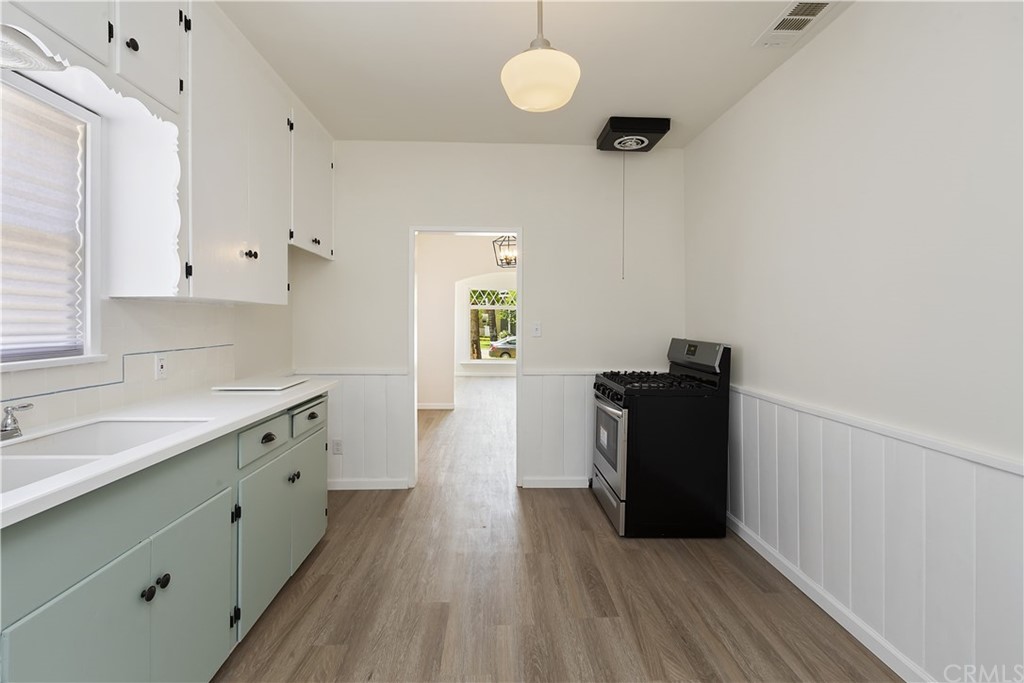 6650 Palm Avenue Riverside, CA 92506 - Photo 10 of 20 a kitchen with granite countertop a refrigerator a sink and wooden floors