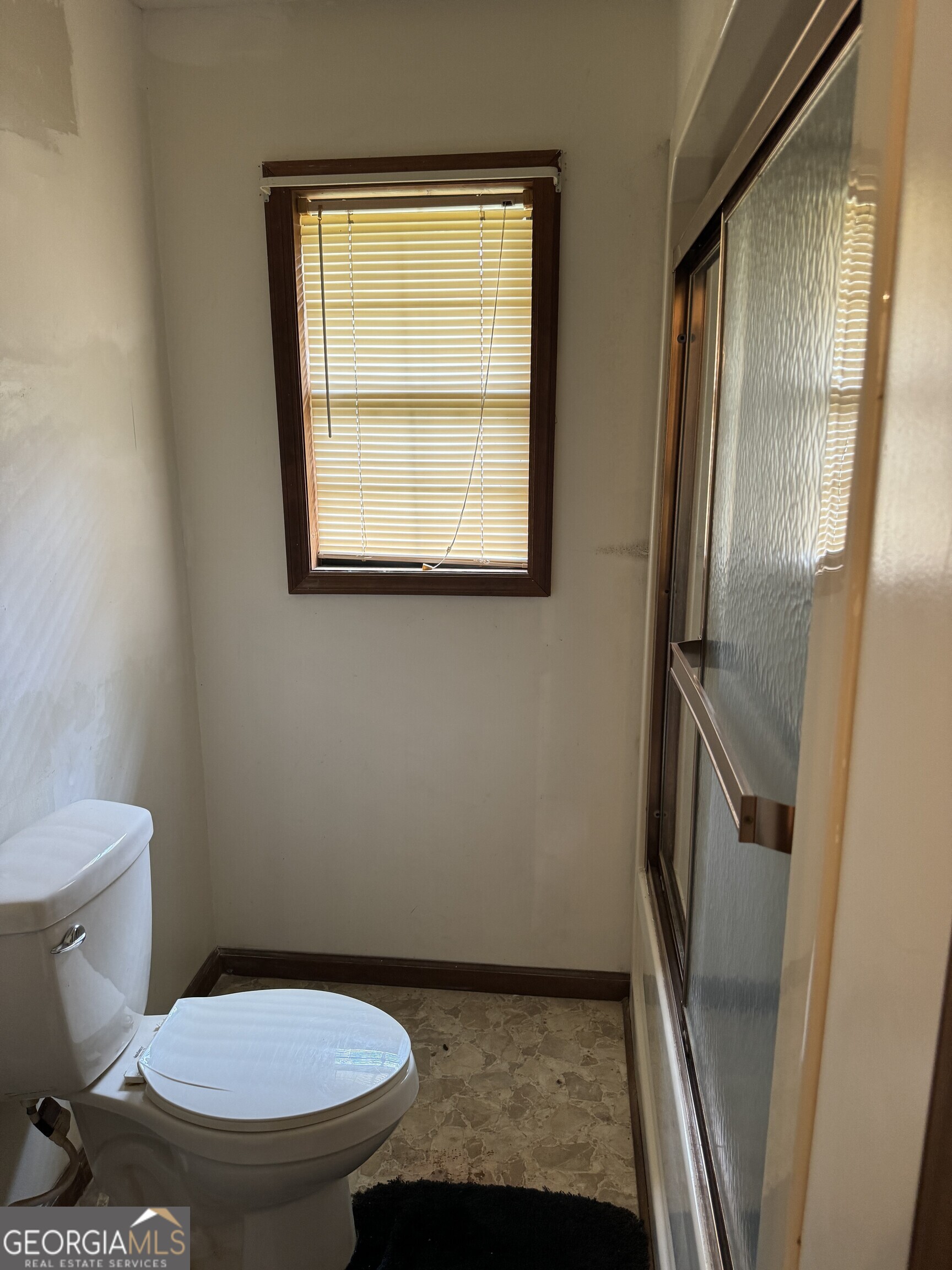 1936 Cedar Grove Road Soperton, GA 30457 - Photo 31 of 43 a bathroom with a granite countertop toilet and a sink