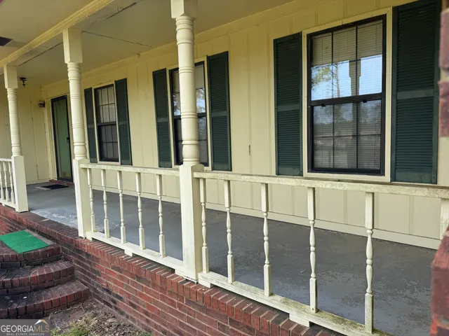 a view of a balcony with wooden floor