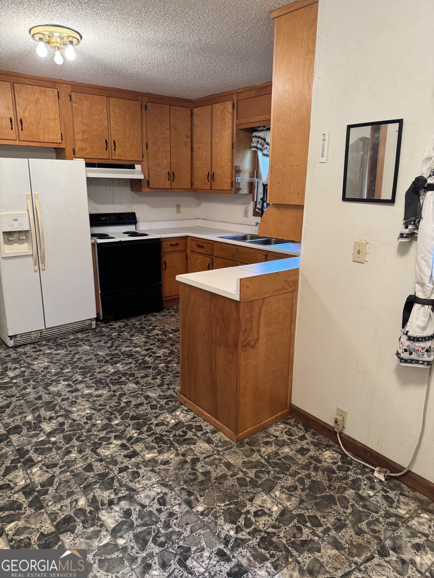 1936 Cedar Grove Road Soperton, GA 30457 - Photo 9 of 43 a kitchen with stainless steel appliances granite countertop a stove a sink and a refrigerator
