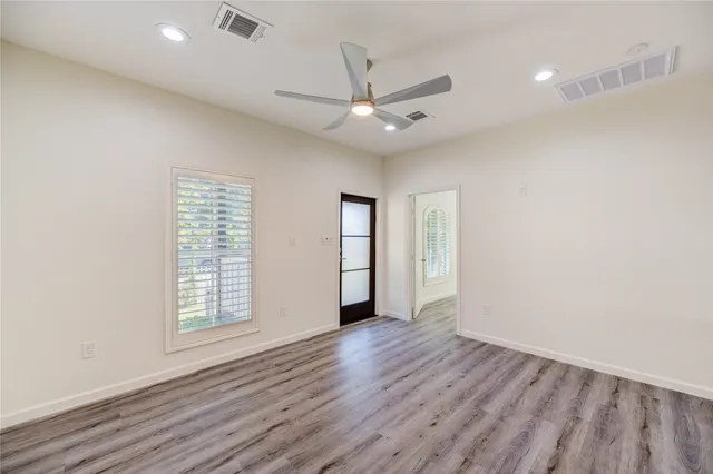 wooden floor in an empty room with a window