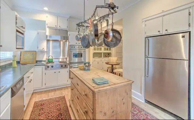 a kitchen with a sink refrigerator and cabinets
