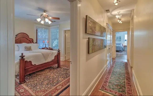 a bedroom with a bed dresser and a mirror