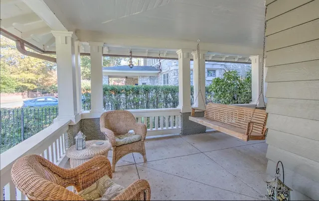 a living room with furniture and a floor to ceiling window