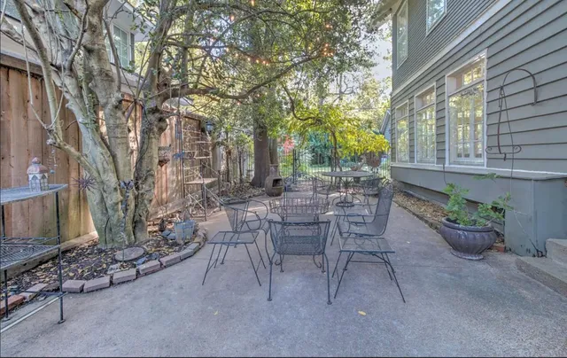 a view of a patio with table and chairs and potted plants