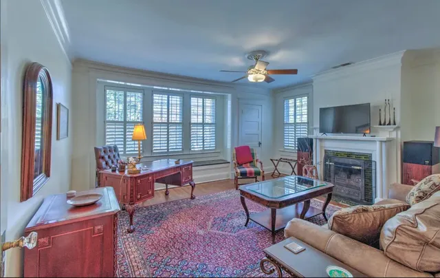 a living room with furniture a fireplace and a flat screen tv