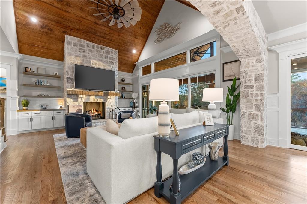 5431 Mayflower Court Gainesville, GA 30504 - Photo 14 of 64 a living room with furniture a flat screen tv and a table