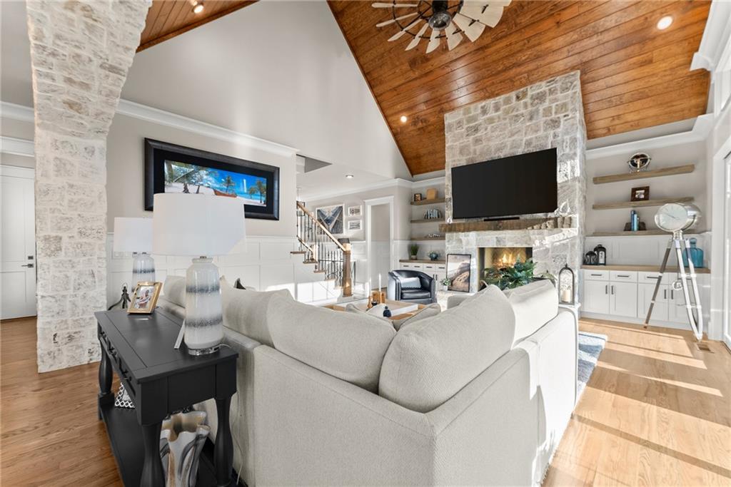 5431 Mayflower Court Gainesville, GA 30504 - Photo 15 of 64 a living room with furniture a flat screen tv and a fireplace