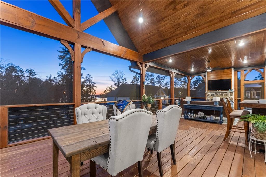 5431 Mayflower Court Gainesville, GA 30504 - Photo 19 of 64 a view of a patio with table and chairs with wooden floor and fence