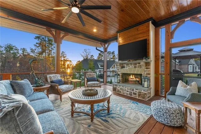 a kitchen with stainless steel appliances granite countertop a stove and chairs with wooden floors