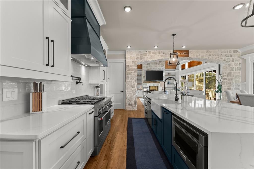 5431 Mayflower Court Gainesville, GA 30504 - Photo 27 of 64 a kitchen with stainless steel appliances kitchen island granite countertop a stove a sink and a refrigerator