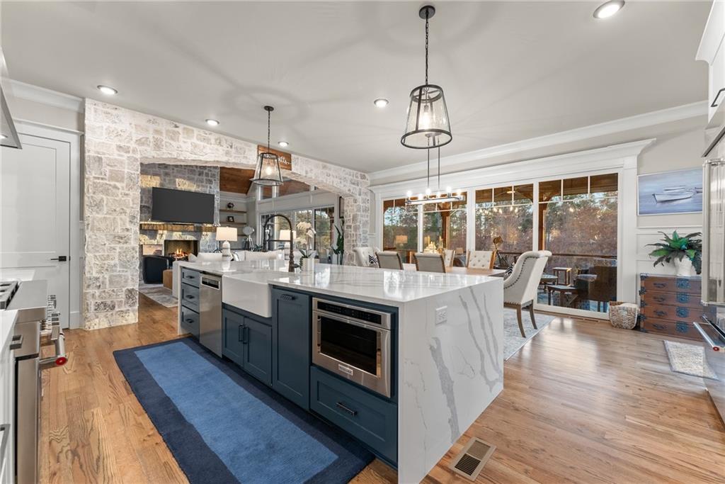 5431 Mayflower Court Gainesville, GA 30504 - Photo 28 of 64 a kitchen with stainless steel appliances granite countertop a stove and chairs with wooden floors