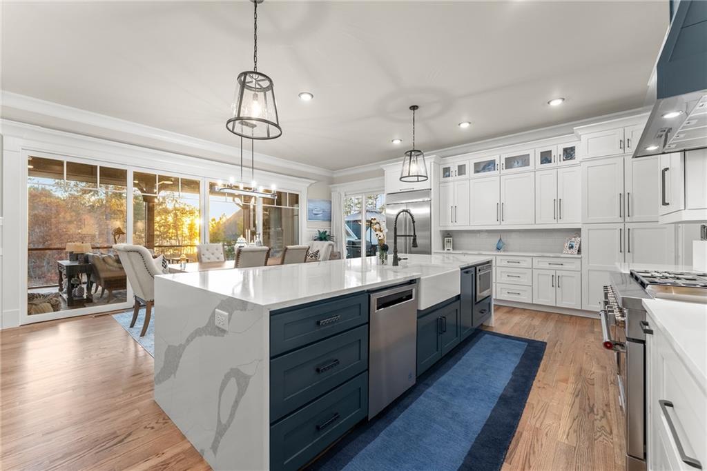 5431 Mayflower Court Gainesville, GA 30504 - Photo 30 of 64 a kitchen with stainless steel appliances granite countertop a lot of counter space and wooden floors