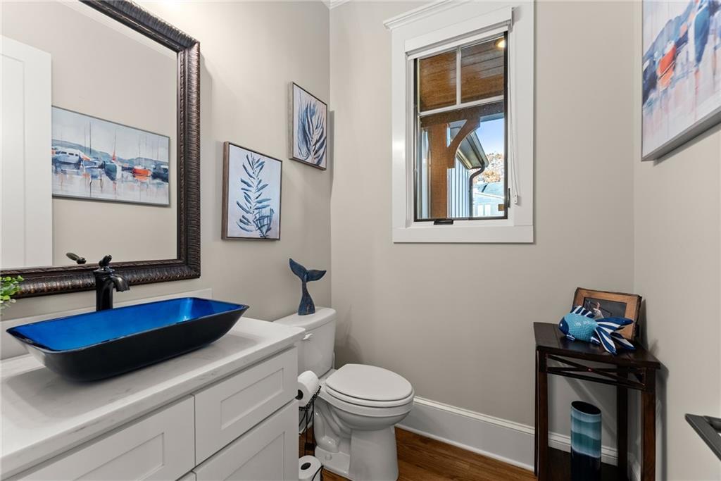 5431 Mayflower Court Gainesville, GA 30504 - Photo 32 of 64 a bathroom with a toilet a sink and a mirror
