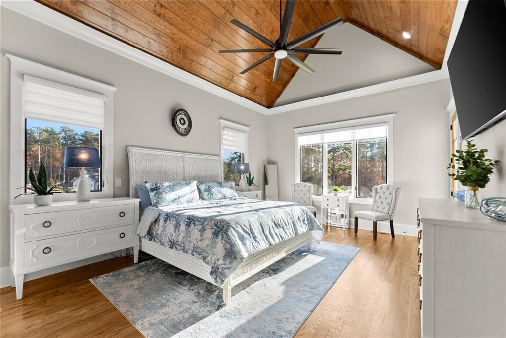 5431 Mayflower Court Gainesville, GA 30504 - Photo 35 of 64 a spacious bedroom with a large bed and a chandelier