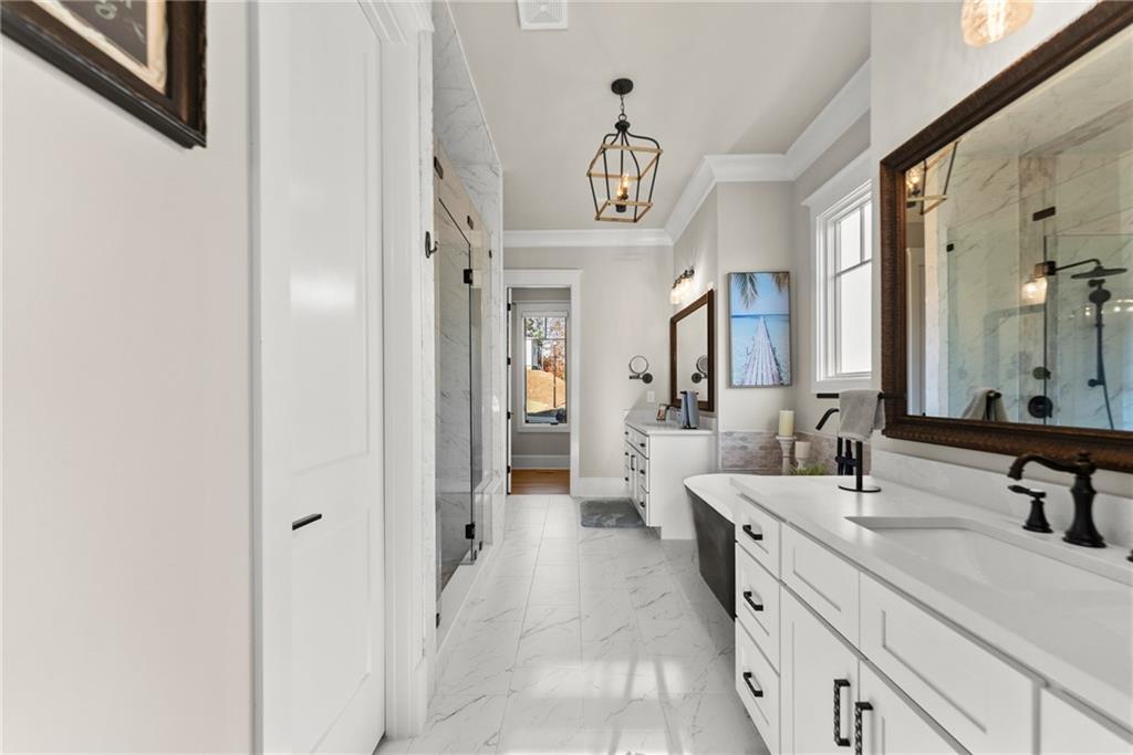 5431 Mayflower Court Gainesville, GA 30504 - Photo 38 of 64 a spacious bathroom with a double vanity sink and a mirror