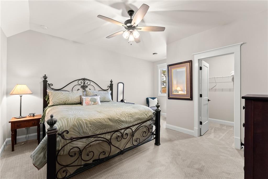 5431 Mayflower Court Gainesville, GA 30504 - Photo 40 of 64 a bedroom with a bed a chandelier and a dresser