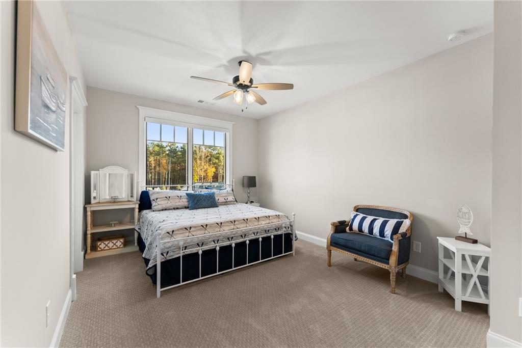 5431 Mayflower Court Gainesville, GA 30504 - Photo 46 of 64 a bedroom with a bed and a chandelier