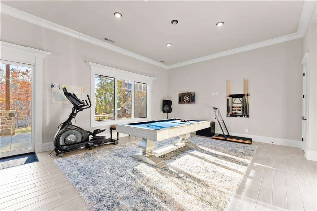 5431 Mayflower Court Gainesville, GA 30504 - Photo 49 of 64 a living room with furniture a window and gym equipment
