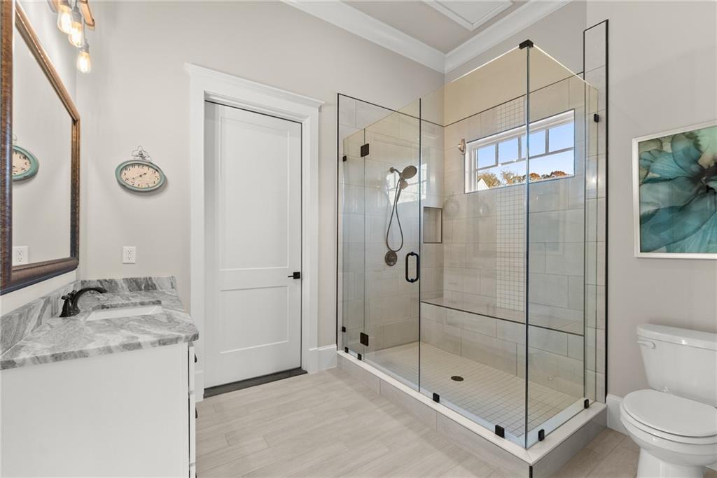 5431 Mayflower Court Gainesville, GA 30504 - Photo 51 of 64 a bathroom with a granite countertop sink mirror shower and toilet